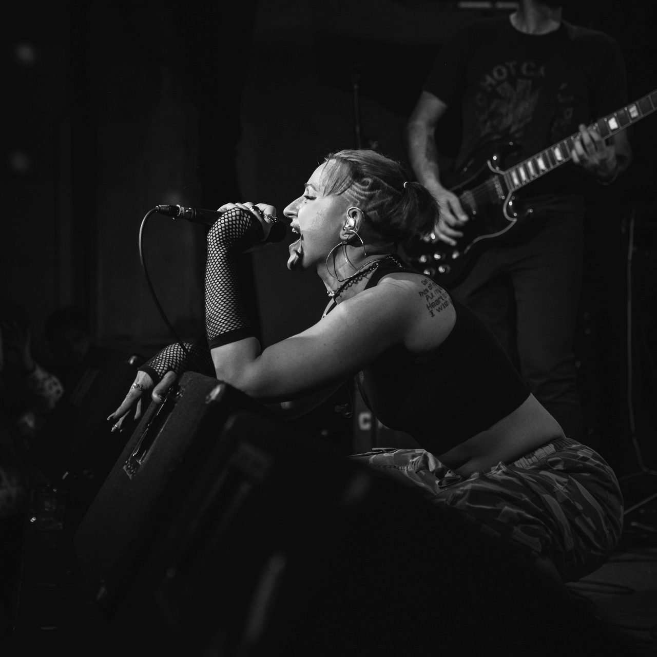 Nicole Haber performing with a microphone onstage